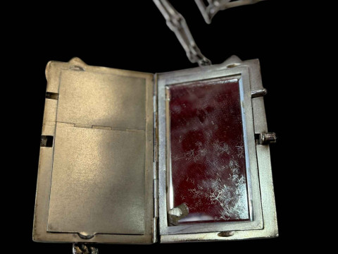 Louis Kuppenheim silver vanity case, the front and back with repousse cat having ruby eyes, fitted interior with cabachon ruby openers, with chain, 10.5cm by 6cm. thumbnail