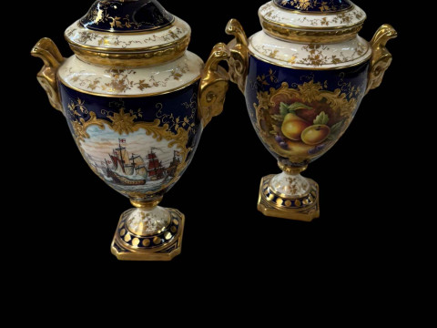 Two Coalport urn vases with covers, one painted by Malcolm Harnet with...