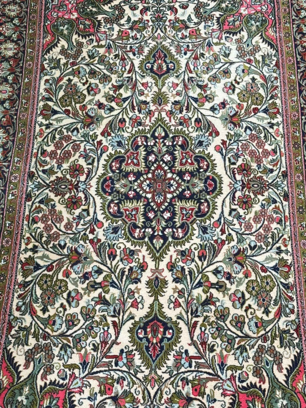 Persian floral decorated rug with pink border, 2.30 by 1.39.