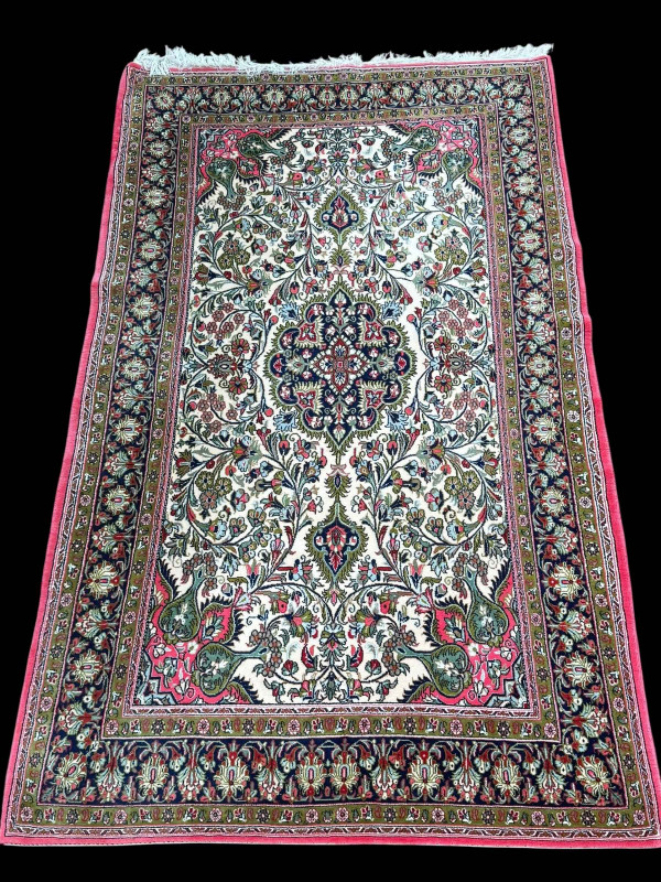 Persian floral decorated rug with pink border, 2.30 by 1.39.