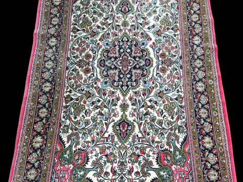 Persian floral decorated rug with pink border, 2.30 by 1.39.