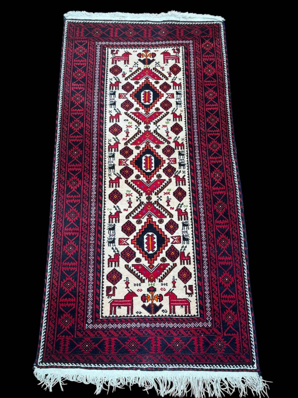 Persian design rug with antlered animal decoration, 2.00 by 0.96.