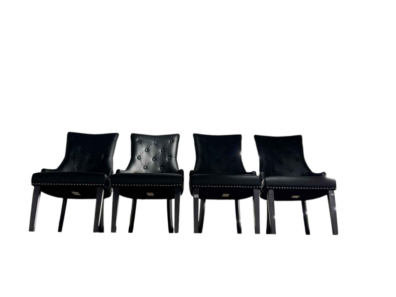 Set of four black buttoned faux leather contemporary dining chairs.