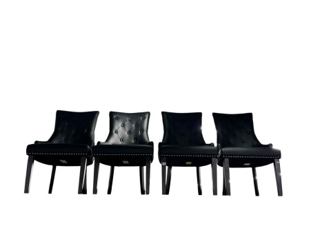 Set of four black buttoned faux leather contemporary dining chairs.