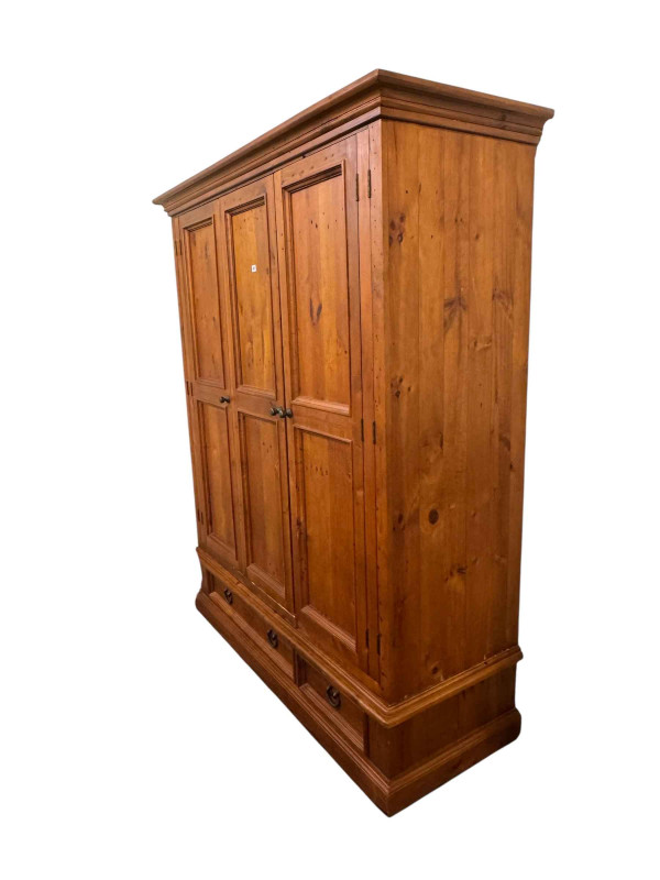Pine triple wardrobe with two base drawers, 202cm by 167cm by 63cm.