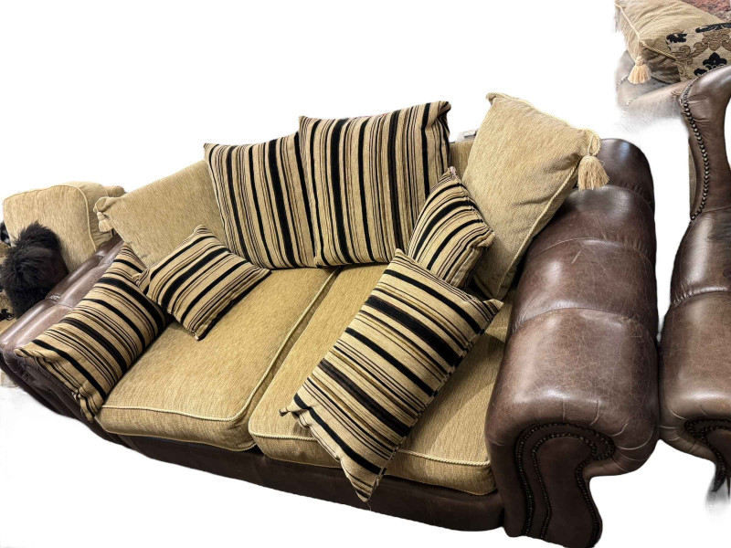 Brown studded leather and fabric five piece lounge suite comprising two seater settee, two chairs, large chair and footstool (some of the legs are not affixed and need attention).