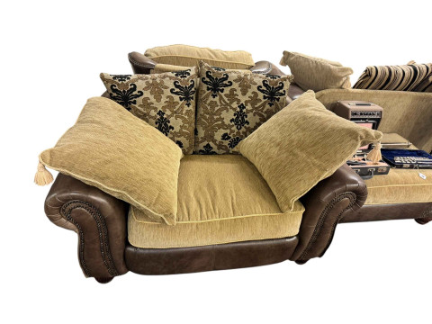 Brown studded leather and fabric five piece lounge suite comprising two seater settee, two chairs, large chair and footstool (some of the legs are not affixed and need attention). thumbnail