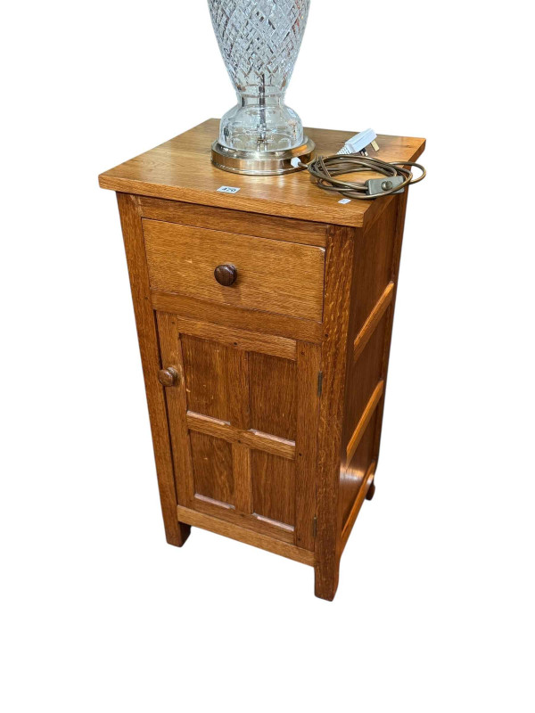 Oak pedestal having single drawer above a panelled cupboard door, 89cm by 45.5cm by 41cm.