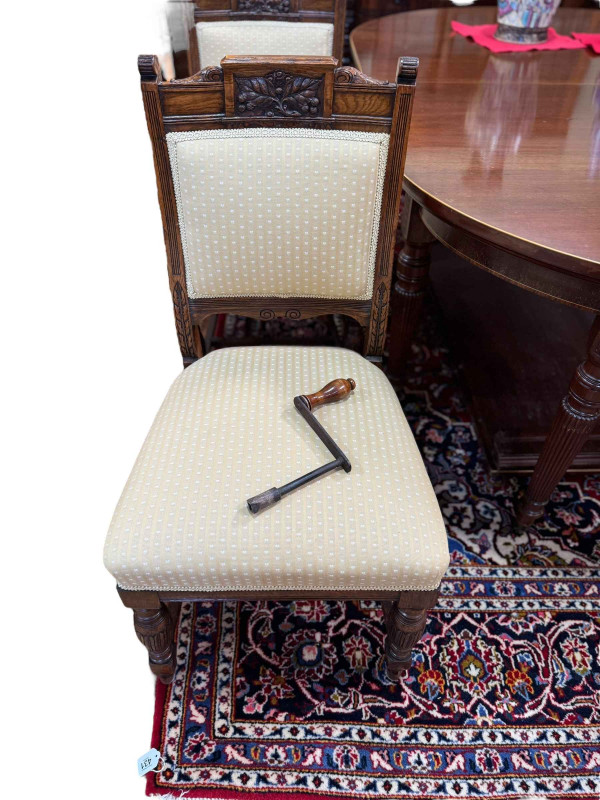 19th Century mahogany and line inlaid oval extending dining table on turned reeded tapering legs with two leaves and winder, 76cm by 122cm by 182cm (excluding leaves), together with a set of six Victorian carved oak dining chairs.