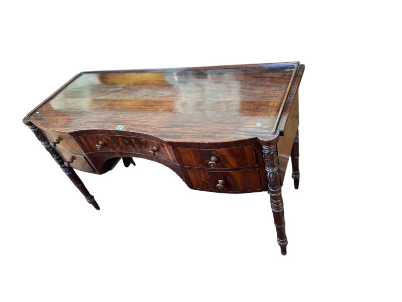 Regency mahogany inverted bow front five drawer dressing table on carved and ring turned legs, 81cm by 132cm by 53cm.