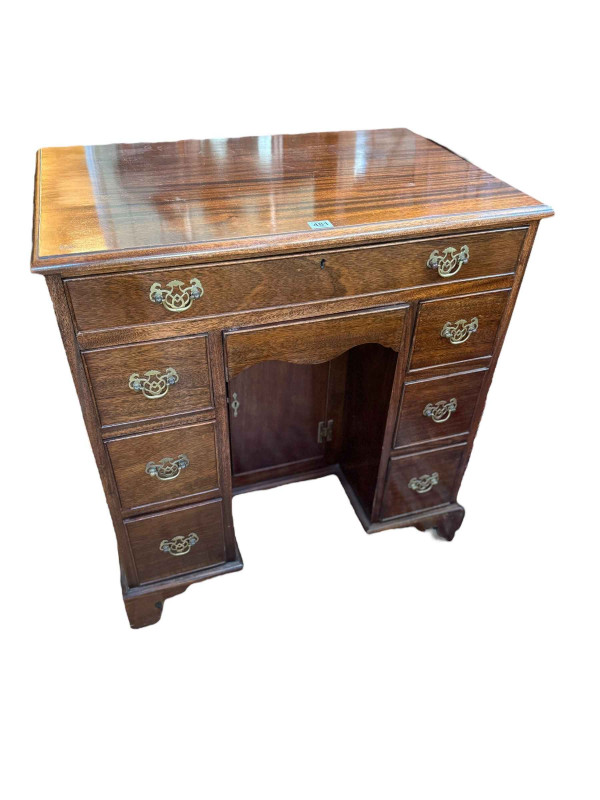 Georgian style mahogany eight drawer kneehole desk having lower inset cupboard door and on bracket feet, 82cm by 76cm by 49cm.