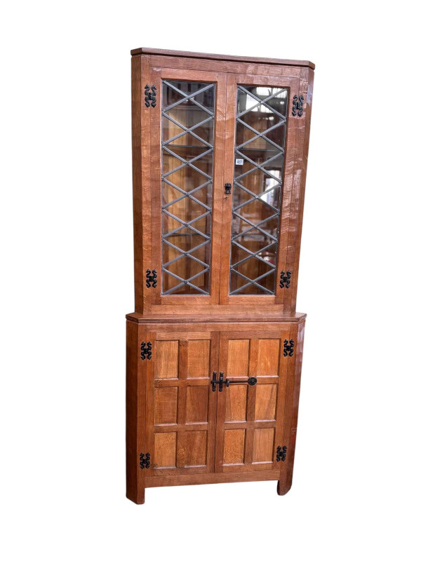 Albert 'Eagleman' Jeffrey adzed oak double standing corner cabinet having a pair of leaded glazed panel doors above a pair of panelled cupboard doors, 198cm.