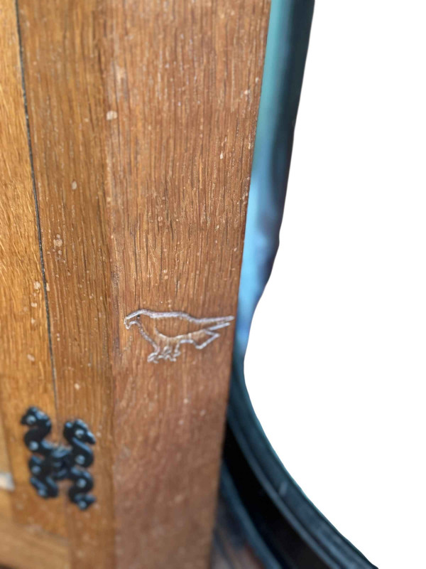 Albert 'Eagleman' Jeffrey adzed oak double standing corner cabinet having a pair of leaded glazed panel doors above a pair of panelled cupboard doors, 198cm.