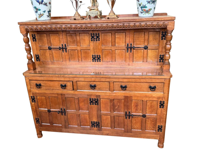 Albert 'Eagleman' Jeffrey oak buffet sideboard having two pairs of upper panelled doors above three drawers with two pairs of panelled cupboard doors below, 134cm by 149cm by 47cm.