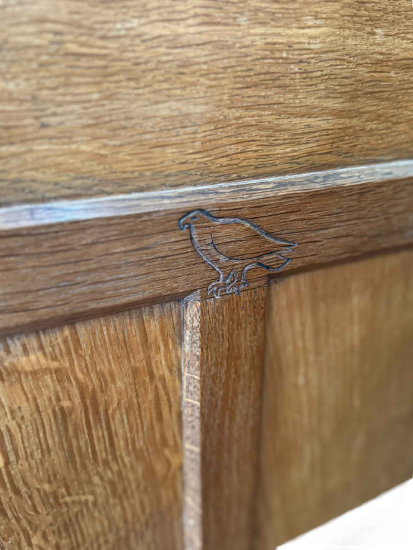 Albert 'Eagleman' Jeffrey oak buffet sideboard having two pairs of upper panelled doors above three drawers with two pairs of panelled cupboard doors below, 134cm by 149cm by 47cm.