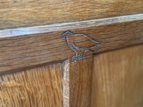 Albert 'Eagleman' Jeffrey oak buffet sideboard having two pairs of upper panelled doors above three drawers with two pairs of panelled cupboard doors below, 134cm by 149cm by 47cm. thumbnail