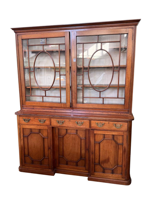 Victorian mahogany cabinet bookcase having two glazed panel doors above three drawers with a central inset cupboard flanked by two cupboard doors below, 207cm by 169cm by 45cm.