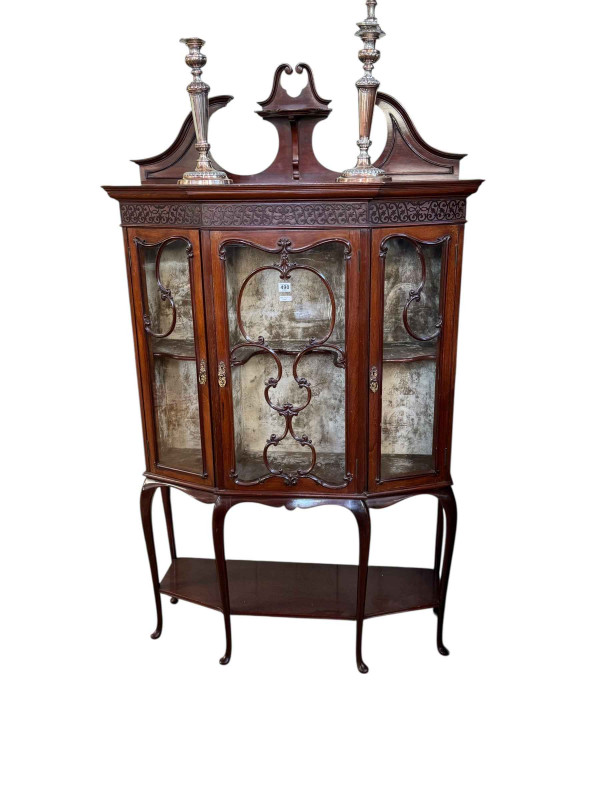 Late Victorian/Edwardian mahogany shaped front three door vitrine having six cabriole legs joined by undershelf, 170cm by 99.5cm by 35cm.