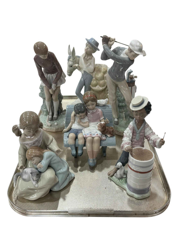Five Lladro figures including male and female golfers and similar group of boy with donkey.