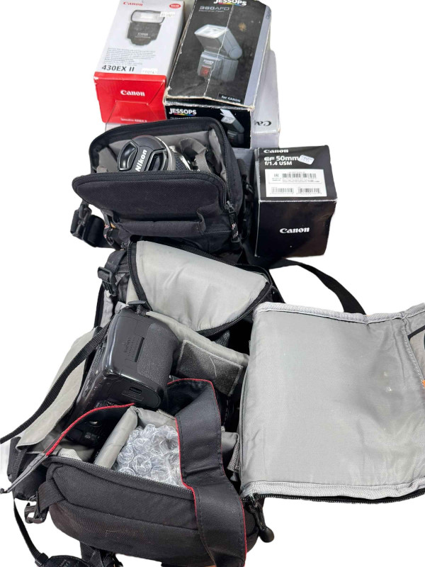 Nikon F75 camera with 28-100 lense, EO5 7D with Sigma DC17/70 lense and original box, Canon Speedlight 430 EX, LowPro bag, etc.