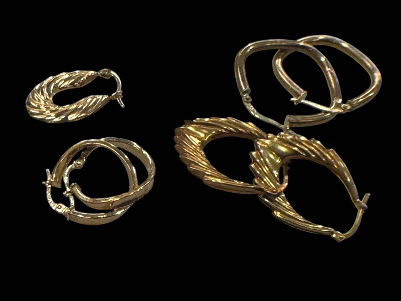 Three pairs of 9 carat gold earrings.