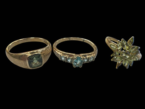 Three 9 carat gold gem set rings.