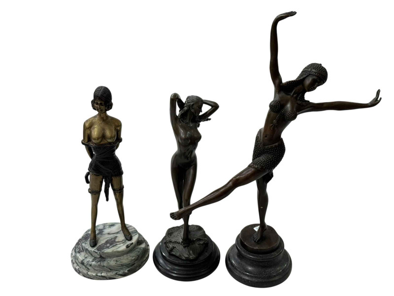 Three Art Deco style lady figures on plinths.