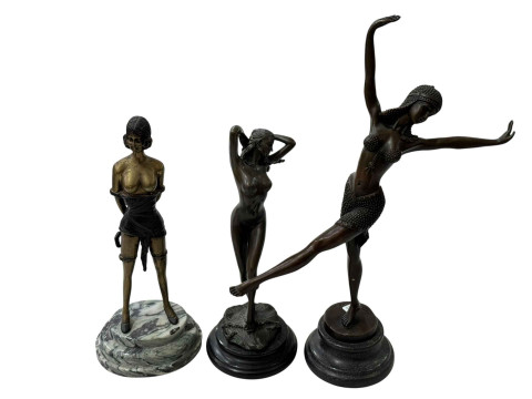 Three Art Deco style lady figures on plinths.