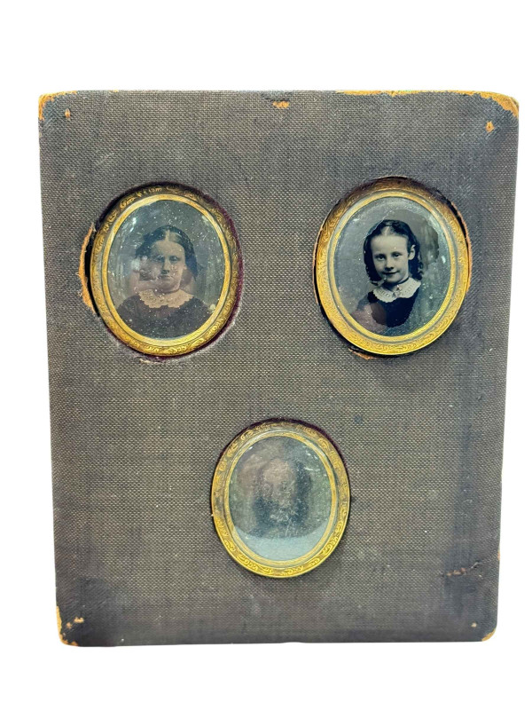 Three mourning lockets containing hair.