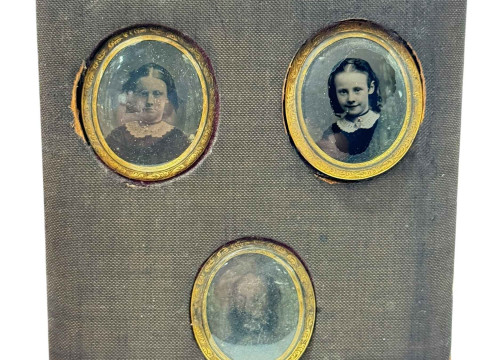 Three mourning lockets containing hair.