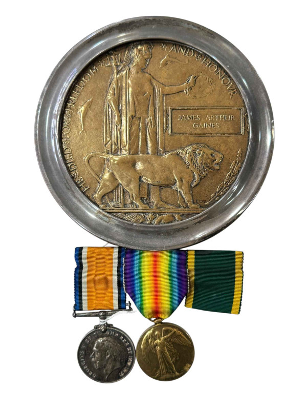 Death penny/plaque named to James Arthur Gaines of the 15th Bn, Royal Scots, together with two WWI medals with ribbons to 'LIEUT F.B. CLEMENT'.