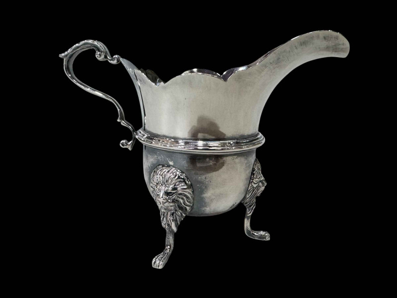 Irish silver cream jug with lion mask legs, Dublin 1917.