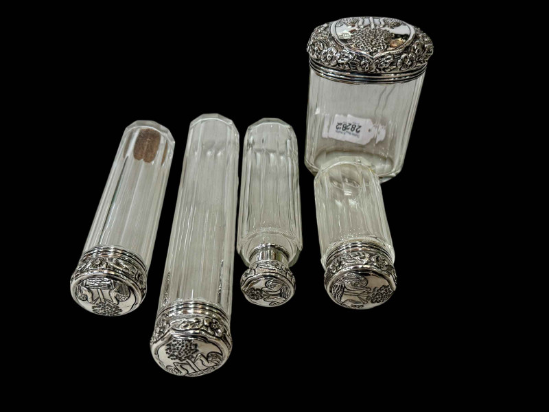 Five silver topped toilet bottles, London 1909.