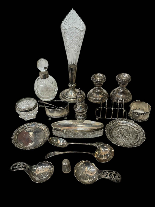 Collection of silver pieces including dwarf candlesticks, cruets, caddy spoons, spoons, scent bottle, etc.
