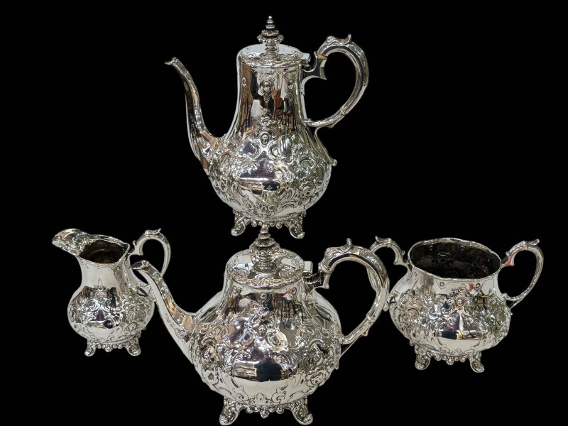 William IV silver four piece tea and coffee set having embossed decoration and on scroll feet, John Walton, Newcastle, 1835.