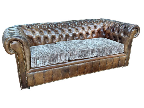Brown buttoned leather and brass studded three seater Chesterfield settee,...