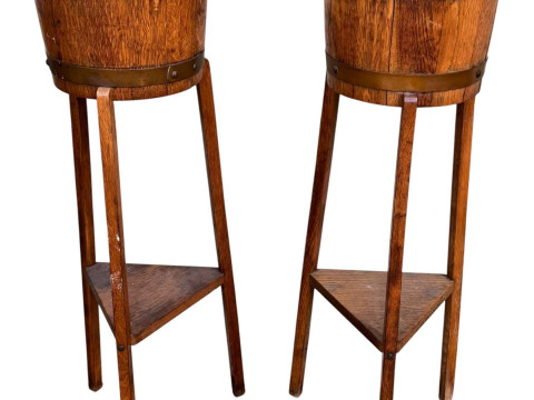 R A Lidster & Co Ltd, pair circular oak and brass bound planters on triform...