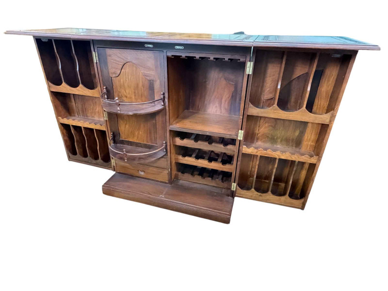 Eastern carved hardwood and brass inlaid cocktail cabinet, the double hinged lid above two doors enclosing a well fitted interior, 117cm by 99cm by 54cm.