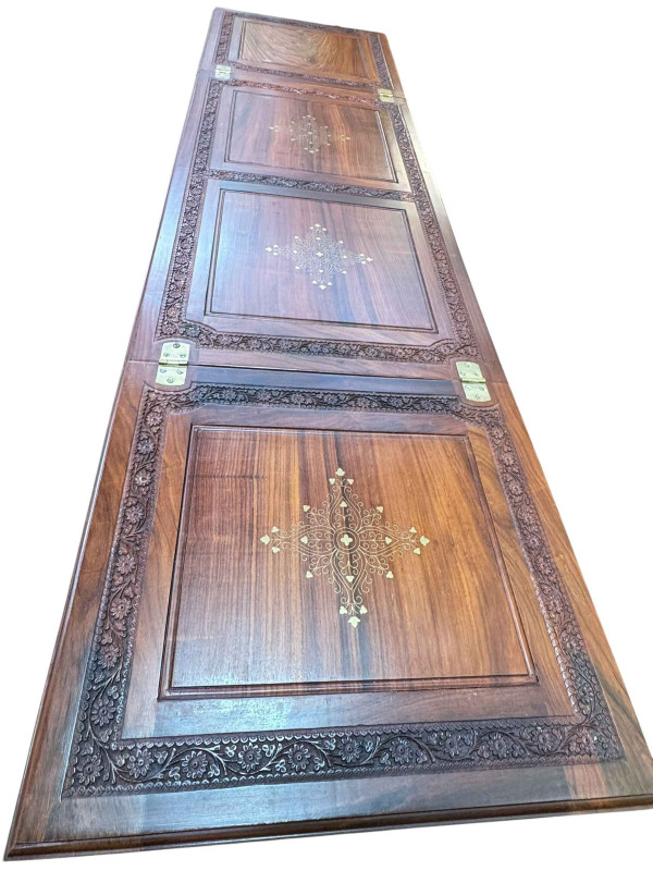 Eastern carved hardwood and brass inlaid cocktail cabinet, the double hinged lid above two doors enclosing a well fitted interior, 117cm by 99cm by 54cm.