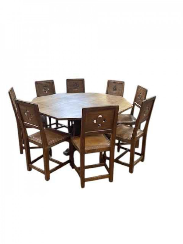 Albert 'Eagleman' Jeffray octagonal adzed oak dining table, 74cm by 144cm, and set of eight Yorkshire Rose panel back dining chairs.