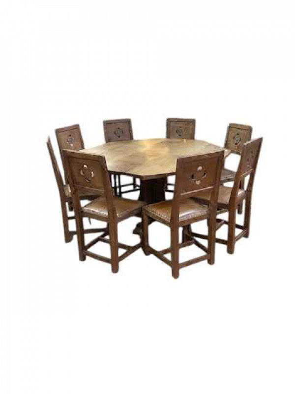 Albert 'Eagleman' Jeffray octagonal adzed oak dining table, 74cm by 144cm, and set of eight Yorkshire Rose panel back dining chairs.
