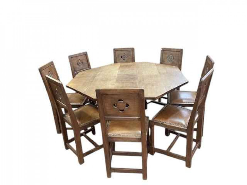 Albert 'Eagleman' Jeffray octagonal adzed oak dining table, 74cm by 144cm, and set of eight Yorkshire Rose panel back dining chairs.