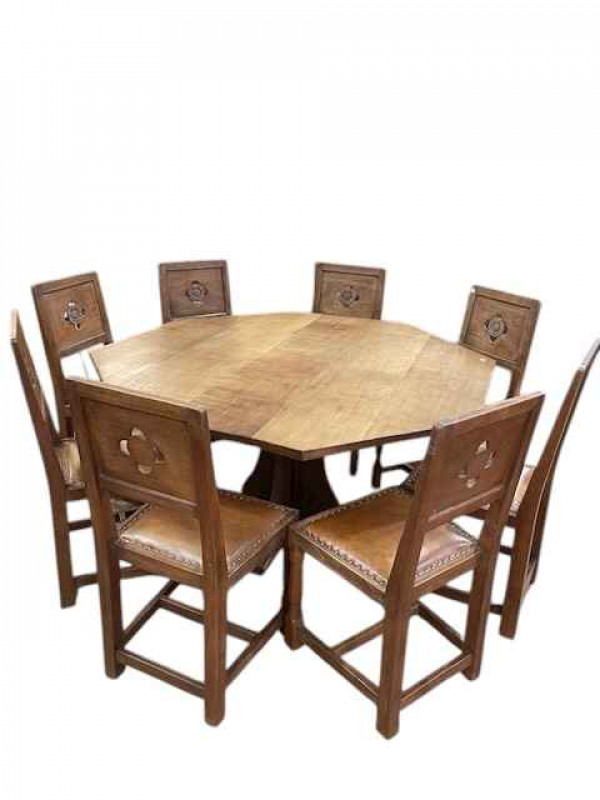 Albert 'Eagleman' Jeffray octagonal adzed oak dining table, 74cm by 144cm, and set of eight Yorkshire Rose panel back dining chairs.