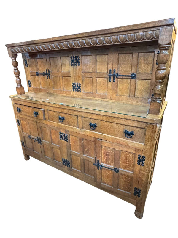 Albert 'Eagleman' Jeffray oak buffet sideboard having two pairs of upper panelled doors above three drawers with two pairs of panelled cupboard doors below, 134cm by 149cm by 47cm.