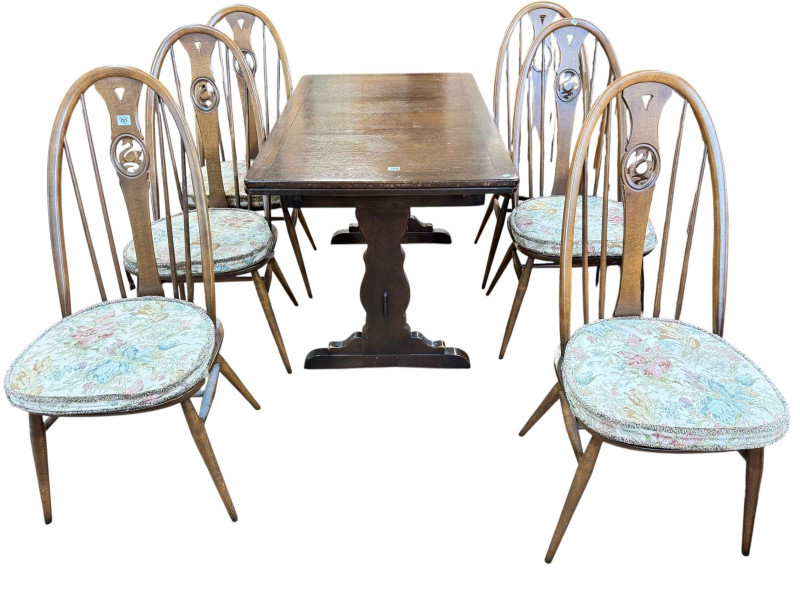 Oak draw leaf dining table, set of six Ercol swan back dining chairs and Ercol armchair with crinoline stretcher (8).
