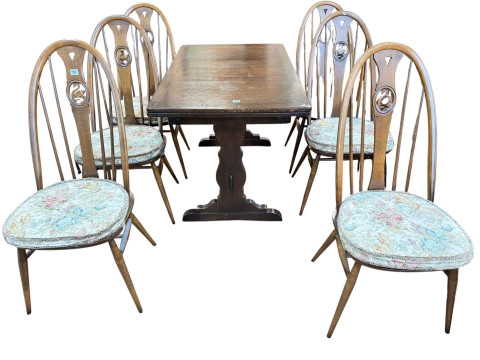Oak draw leaf dining table, set of six Ercol swan back dining chairs and...