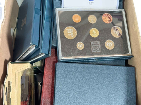 Royal Mint UK proof coin sets, diecast vehicles, Matchbox labels.