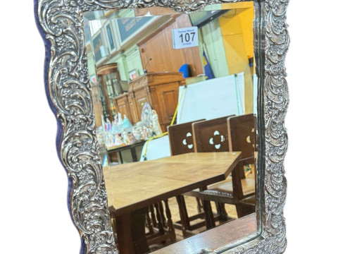 Easel bevelled mirror in ornate frame.