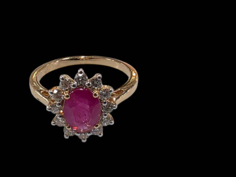 18 carat yellow gold, ruby and diamond cluster ring, the oval ruby 1 carat...