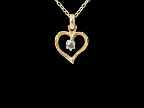 9 carat gold necklace with sapphire set heart shaped pendant.